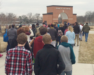 Students walk away from the football stadium and toward the West Gym after the school was evacuated on Wednesday afternoon.