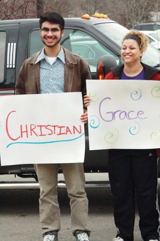 Holding the signs StuCo made them, senior Youth of the Year candidates Christian Espinosa and Grace Barr took the limo in the background to the Lawrence Arts Center to prepare for the competition.