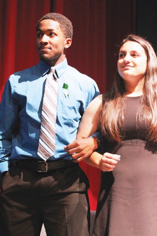 Senior Ivan Hollins stands at the homecoming assembly before the video debuted. Hollins was not able to participate in the crowning ceremony because he was in the football game.